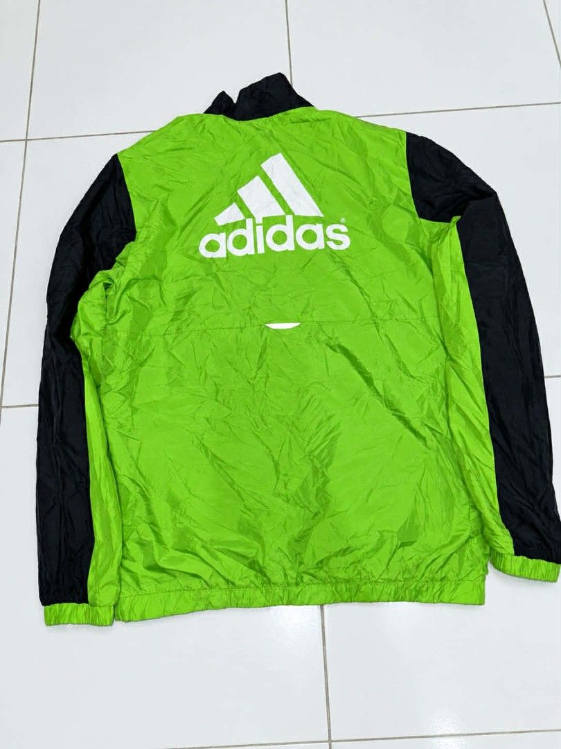 Adidas Windbreaker Jacket Green Black (Category: Coats, Jackets and Outerwear) located in Bulacan. Submitted by annenicathriftthriftlang (Listing ID 1462322479, Image 2). Description: - Adidas jacket in green and black - Full zip front closure - Adidas logo on the front - Large Adidas logo graphic on the back - Lightweight material - Ideal for casual wear or sports activities.