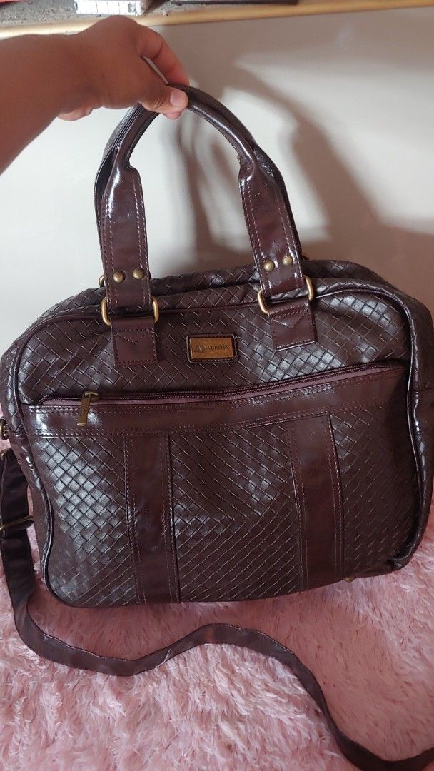 ADRENA Brown Woven Leather Handbag Shoulder Bag (Category: Shoulder Bags) located in Kitaotao. Submitted by wilddolphin.0a0db3 (Listing ID 1462394825, Image 1). Description: - Stylish ADRENA brown handbag - Beautiful woven leather exterior - Comfortable top handles - Includes a detachable shoulder strap for versatility - Spacious interior with convenient pockets - Secure zipper closure - ADRENA branding visible on zipper pull and metal tag.