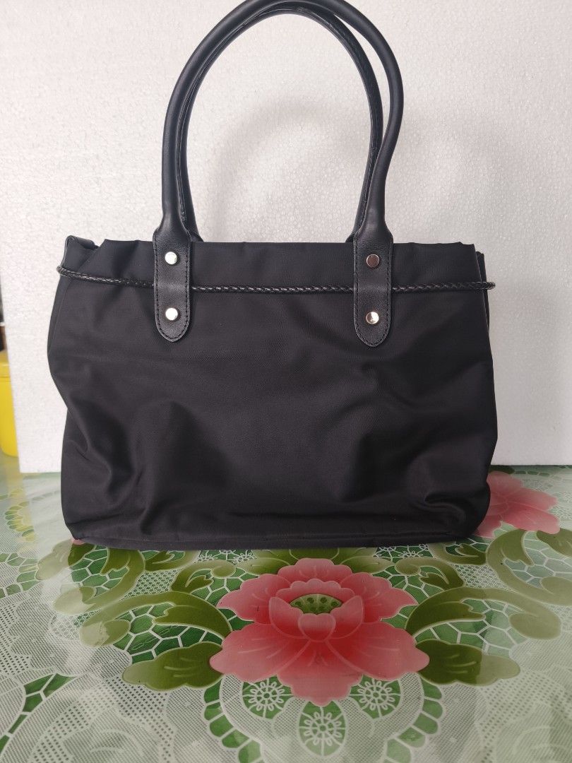 Agnès b. Nylon Tote Bag (Category: Tote Bags) located in San Juan City. Submitted by vingabby (Listing ID 1462278606, Image 2). Description: - Stylish black nylon tote bag - Genuine leather handles - Elegant braided drawstring detail - Gold hardware accents - Ample interior space for essentials - Ideal for everyday use .