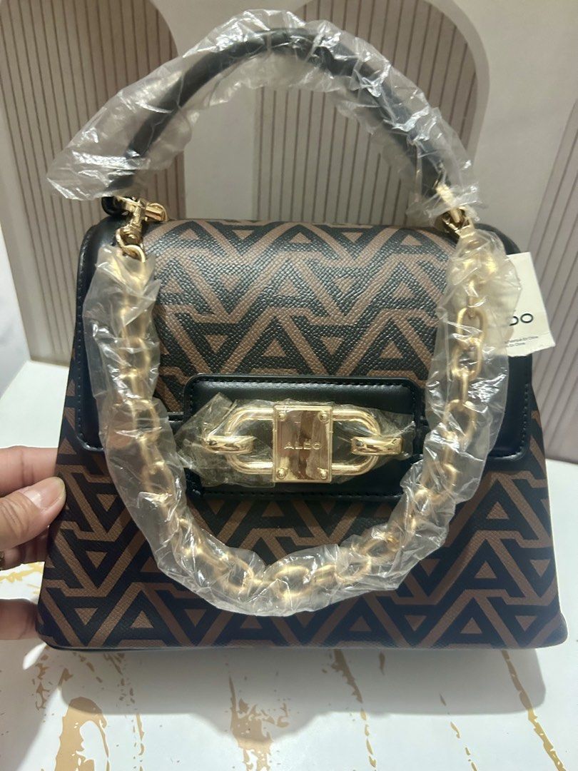 ALDO Geometric Print Chain Handle Handbag (Category: Luxury Bags & Wallets) located in Manila. Submitted by trendsby_t (Listing ID 1462424151, Image 1). Description: - NEVER BEEN USED, may plastic pa - with minimal “FLAW”, pls take a look at the last pic. Di po halata pag nakasara Ang bag. 💼 👍 - with extra long strap -Stylish brown and black geometric print handbag. - Elegant gold chain detail on the front flap. - Versatile with a top handle an