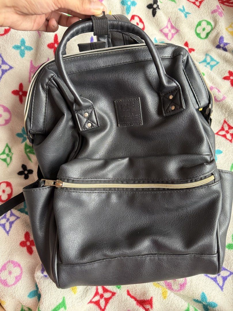 Anello Small Black Leather Backpack (Category: Backpacks) located in Quezon City. Submitted by krtstn (Listing ID 1462289593, Image 1). Description: - Black faux leather backpack - Main compartment with internal pockets - Front zipper pocket - Side pockets - Adjustable straps - Ideal for everyday use or travel - Bought in Japan.