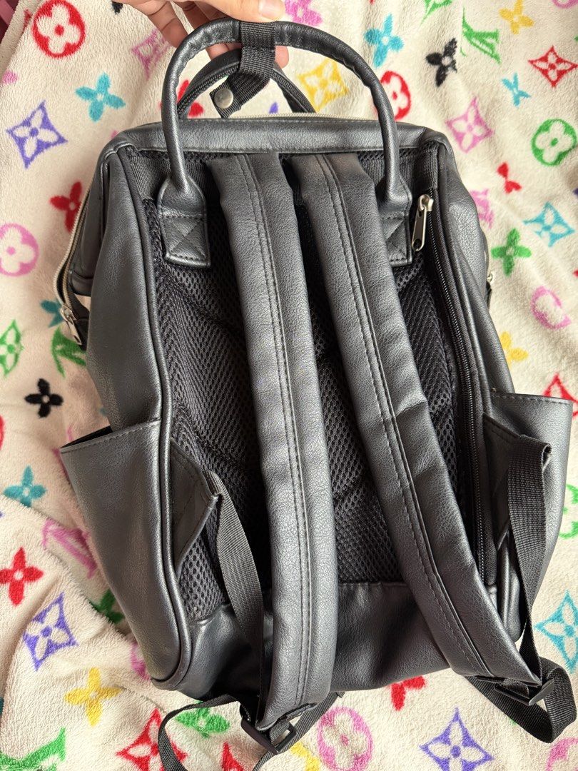 Anello Small Black Leather Backpack (Category: Backpacks) located in Quezon City. Submitted by krtstn (Listing ID 1462289593, Image 2). Description: - Black faux leather backpack - Main compartment with internal pockets - Front zipper pocket - Side pockets - Adjustable straps - Ideal for everyday use or travel - Bought in Japan.