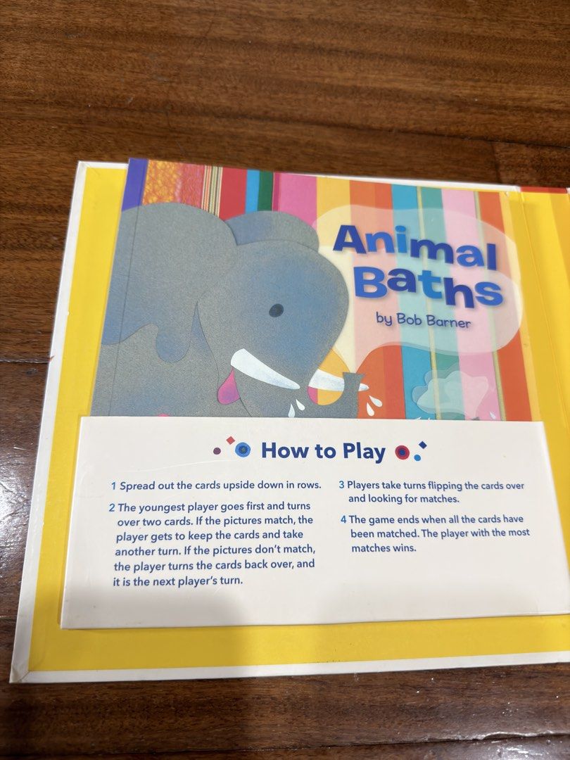 Animal Baths Book & Matching Game Set by Bob Barner (Category: Children's Books) located in San Juan City. Submitted by addieandmatty (Listing ID 1462284255, Image 2). Description: - Fun matching game perfect for little ones. - Includes a book about animals and bath time. - Features cute animal illustrations on cards (elephants, rhinos, toucans). - Great for learning and play. - Easy to learn with included instructions..