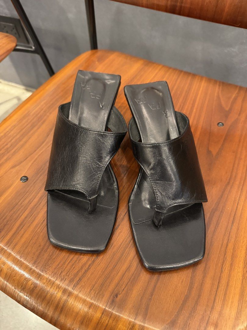 APARA Asymmetrical Wedge Heels in Black Leather (Category: Heels) located in Manila. Submitted by declutterkween14 (Listing ID 1462335613, Image 2). Description: - Brand: APARA - Color: Black - Material: Leather - Style: Asymmetrical wedge heels - Toe: Square toe - Detail: Thong strap - Heel: Comfortable wedge - Original Price: P6,200.00 - Sizing: Refer to size chart for measurements.