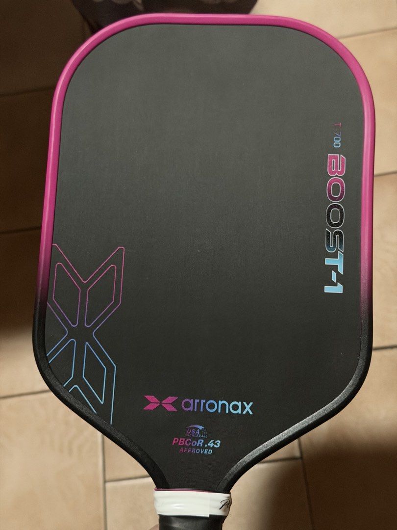 Arronax T-700 Boost-1 Pickleball Paddle (Category: Racket and Ball Sports) located in Dumaguete. Submitted by thrift_cartel (Listing ID 1462383464, Image 1). Description: - Arronax T-700 Boost-1 Pickleball Paddle - USA Pickleball Approved - PBCor.43 Rating - Stylish black surface with pink and blue accents - Designed to boost your pickleball performance - Ready for immediate play.