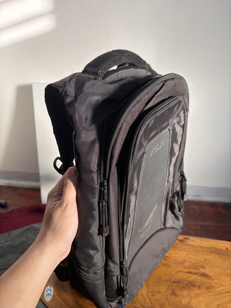 ASUS ROG Backpack for Laptops (Category: Backpacks) located in Quezon City. Submitted by jasonmaverickb.1 (Listing ID 1462327515, Image 2). Description: - Black ASUS ROG backpack - Spacious interior for laptop and gear - Multiple compartments and pockets for organization - Padded straps for comfortable carrying - Durable material, smooth zippers - Great for school, work, or travel Mukhang kupas sa pictures pero ok pa tapaga color niya Never been 