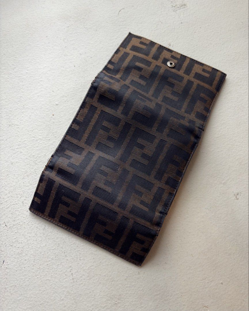 Authentic Fendi Zucca FF Canvas Trifold Wallet (Category: Luxury Bags & Wallets) located in Mandaluyong City. Submitted by wear_your_style (Listing ID 1462293065, Image 2). Description: Vintage. Made in Italy. Bought preloved in Japan. Super nice pa. This is rare coz it’s trifold. Maraming malagay. No rip, no tears. Well-structured pa tong wallet na to. Outside is canvas and inside is leather. Parang coffee brown ang color. Snap closures are good