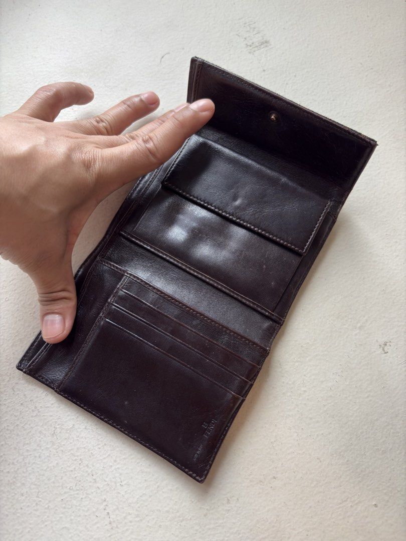 Authentic Fendi Zucca FF Canvas Trifold Wallet (Category: Luxury Bags & Wallets) located in Mandaluyong City. Submitted by wear_your_style (Listing ID 1462293065, Image 3). Description: Vintage. Made in Italy. Bought preloved in Japan. Super nice pa. This is rare coz it’s trifold. Maraming malagay. No rip, no tears. Well-structured pa tong wallet na to. Outside is canvas and inside is leather. Parang coffee brown ang color. Snap closures are good