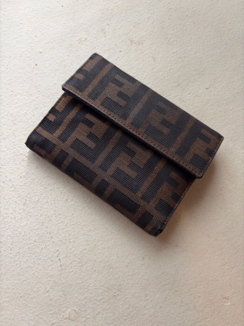 Authentic Fendi Zucca FF Canvas Trifold Wallet (Category: Luxury Bags & Wallets) located in Mandaluyong City. Submitted by wear_your_style (Listing ID 1462293065, Image 1). Description: Vintage. Made in Italy. Bought preloved in Japan. Super nice pa. This is rare coz it’s trifold. Maraming malagay. No rip, no tears. Well-structured pa tong wallet na to. Outside is canvas and inside is leather. Parang coffee brown ang color. Snap closures are good