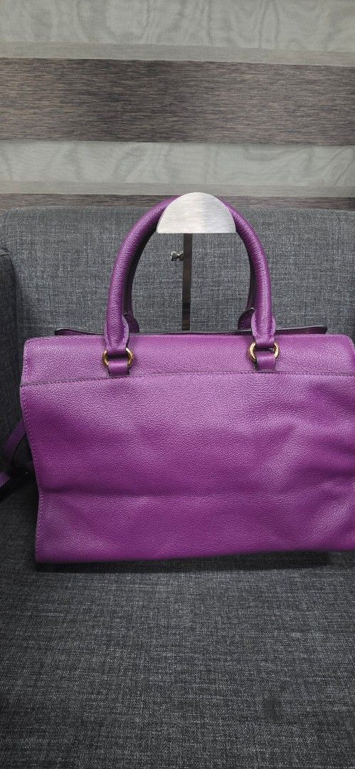 Authentic Prada Milano Leather Tote Bag Purple (Category: Shoulder Bags) located in General Trias. Submitted by roselle2230 (Listing ID 1462414898, Image 2). Description: - Purple Leather Prada Tote Bag - Elegant Gold Hardware Details - Versatile: Top Handles & Detachable Shoulder Strap - Secure Zip-Top Main Compartment - Convenient Front Flap Pocket with Buckle Closure - Expertly Crafted in Italy - Ideal for Everyday or Special Events.