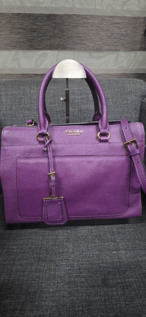 Authentic Prada Milano Leather Tote Bag Purple (Category: Shoulder Bags) located in General Trias. Submitted by roselle2230 (Listing ID 1462414898, Image 1). Description: - Purple Leather Prada Tote Bag - Elegant Gold Hardware Details - Versatile: Top Handles & Detachable Shoulder Strap - Secure Zip-Top Main Compartment - Convenient Front Flap Pocket with Buckle Closure - Expertly Crafted in Italy - Ideal for Everyday or Special Events.