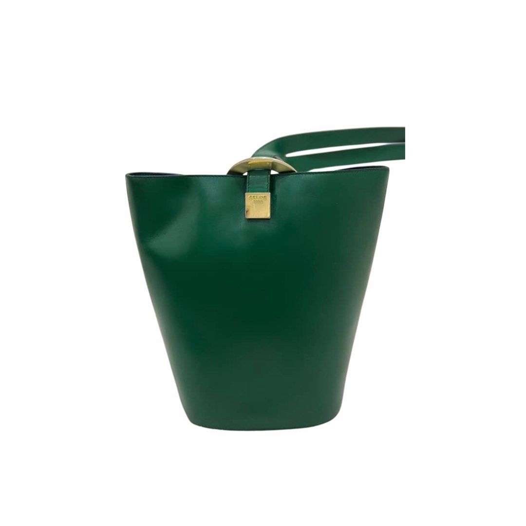 Authentic Vintage Celine Circle Logo Bucket Bag (Category: Luxury Bags & Wallets) located in Manila. Submitted by ladybagmnl (Listing ID 1462324494, Image 2). Description: Rare vintage Celine bucket bag in deep green with gold hardware. Classic minimalist piece with a really nice structure.Features two interior pockets (one zipped, one slip pocket). DM for more photos Material: Leather Size: 11"Wx 10.8"H (approx.) Condition: Excellent vintage con