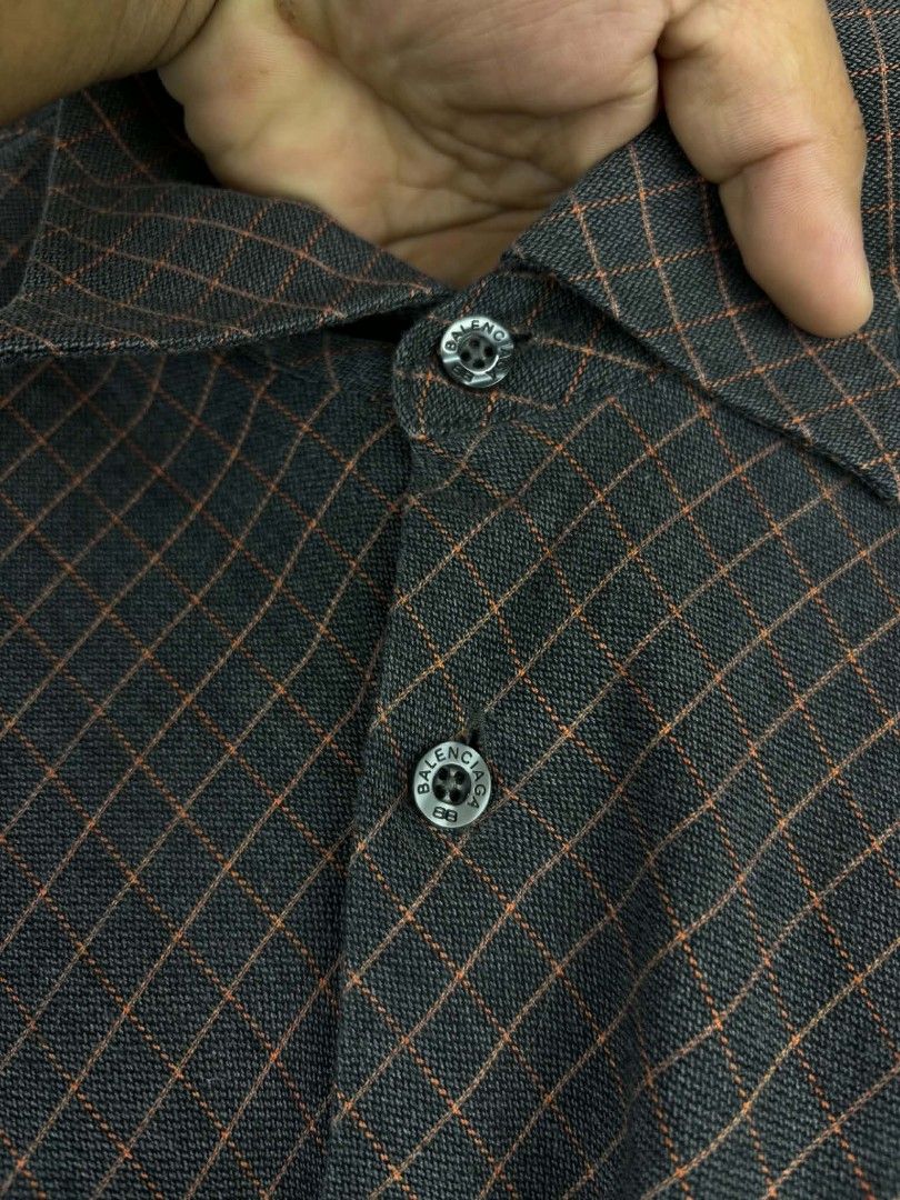 Balenciaga Button-Up Shirt - Grey Plaid Pattern (Category: Tshirts & Polo Shirts ) located in Tanza. Submitted by aldrintamayo (Listing ID 1462305232, Image 3). Description: - Balenciaga button-up shirt - Color: Grey with orange plaid pattern - Style: Classic collar, button-down front - Features: Single chest pocket - Size: Tag shows 6 (185/96A) - Ideal for: Smart casual outfits.