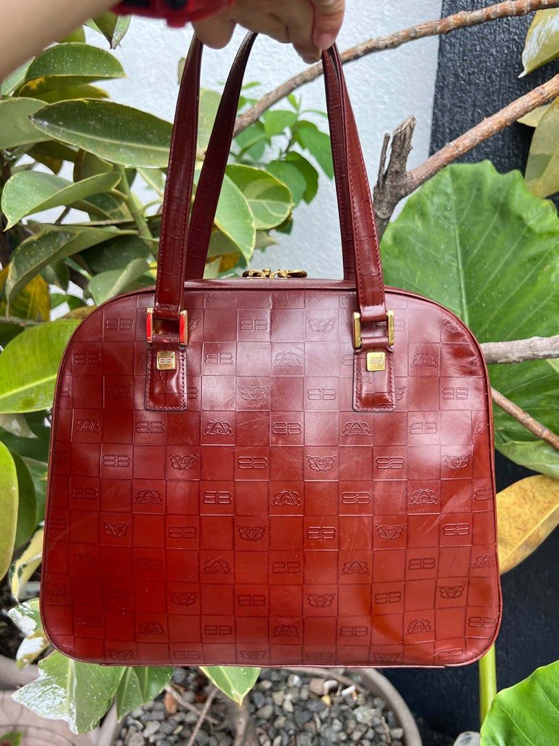 Balenciaga Paris Monogram Shoulder Bag (Category: Luxury Bags & Wallets) located in Bacolod City. Submitted by novymaesel14868 (Listing ID 1462339135, Image 1). Description: - Vintage Balenciaga shoulder bag - Rich burgundy color with embossed monogram pattern - Gold hardware details - Interior zippered pocket - Balenciaga logo on zipper pull - Classic piece, great for daily use.