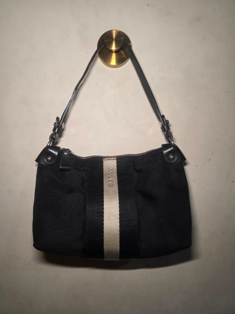 BALLY Canvas with Leather Strap Pochette Shoulder Bag (Authentic) (Category: Luxury Bags & Wallets) located in Manila. Submitted by dcory (Listing ID 1462345978, Image 2). Description: Brand: Bally Material: Canvas Color: Black Width: 9 inches Height: 5.5 inches Interior Pockets: One zipped pocket, Two flat pockets - With serial code - Please expect signs of wear and a few scratches since this is a preloved item.