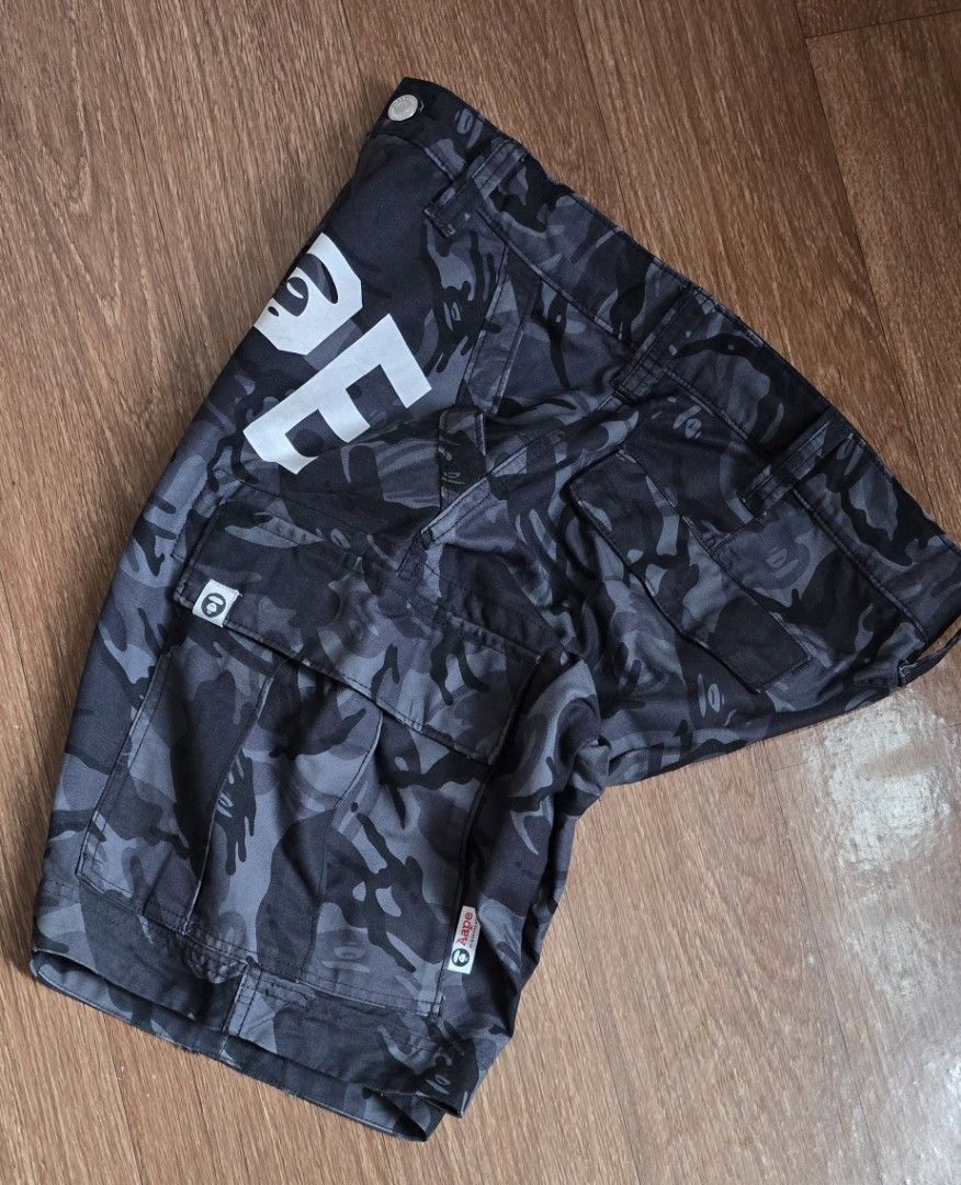 BAPE APE Camo Cargo Shorts (Category: Shorts) located in Quezon. Submitted by archivesss_666 (Listing ID 1462373817, Image 3). Description: - Authentic BAPE Grey Camo Cargo Shorts - Iconic APE logo and text graphic on the front - Multiple functional pockets for ample storage - Classic streetwear aesthetic - Perfect for everyday casual wear.