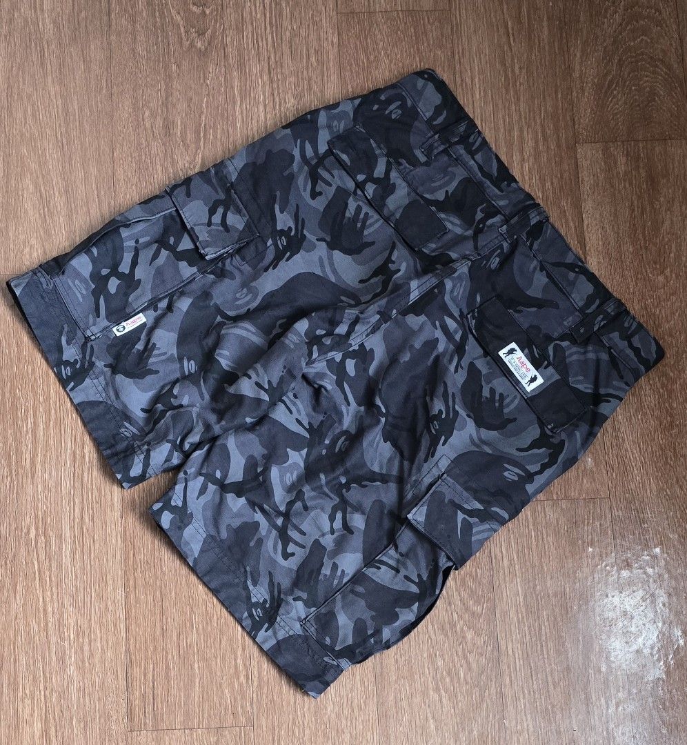 BAPE APE Camo Cargo Shorts (Category: Shorts) located in Quezon. Submitted by archivesss_666 (Listing ID 1462373817, Image 2). Description: - Authentic BAPE Grey Camo Cargo Shorts - Iconic APE logo and text graphic on the front - Multiple functional pockets for ample storage - Classic streetwear aesthetic - Perfect for everyday casual wear.