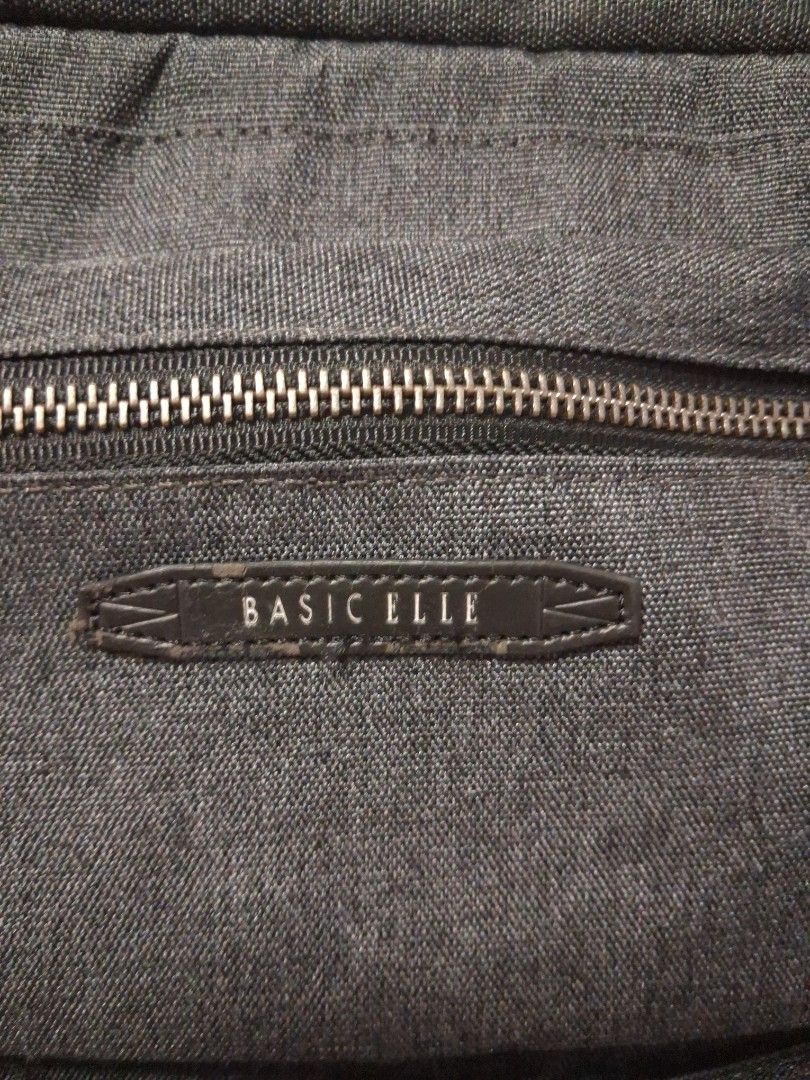 BASIC ELLE Dark Grey Backpack (Category: Backpacks) located in Angeles City. Submitted by anneps (Listing ID 1462407741, Image 3). Description: - Dark grey BASIC ELLE backpack - Multiple compartments and pockets for organization - Padded straps for comfortable carrying - Sturdy zippers with a good feel - Spacious interior, perfect for daily use or travel.