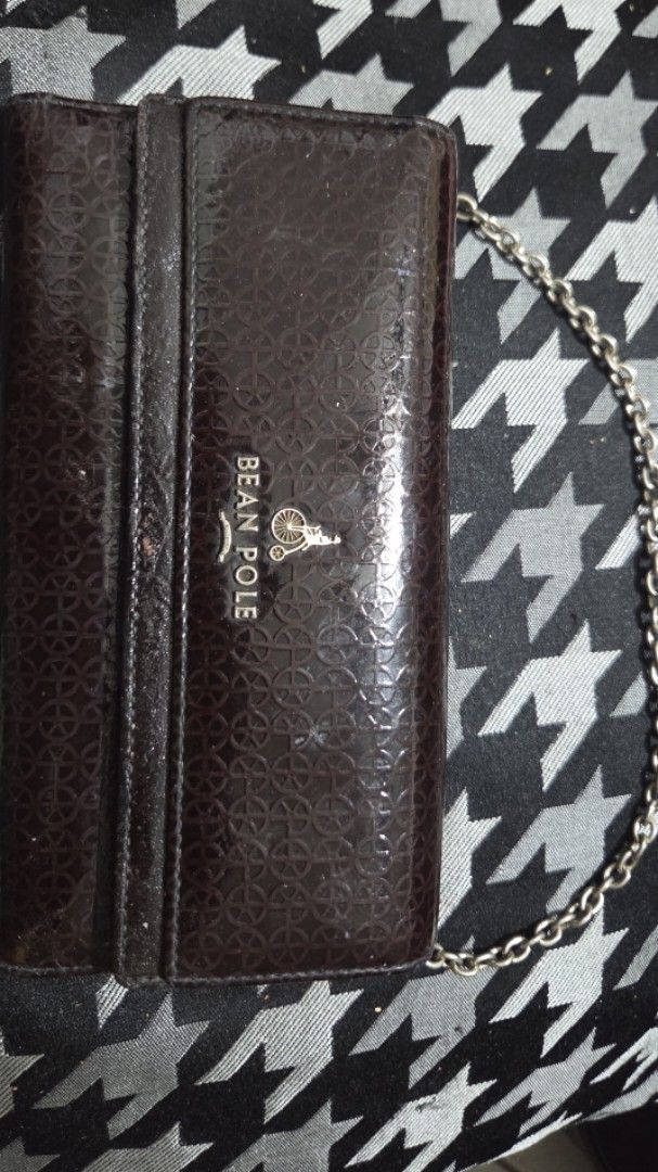 Bean Pole Patent Leather Wallet with Chain (Category: Luxury Bags & Wallets) located in Quezon City. Submitted by kctheexplorer05 (Listing ID 1462331488, Image 1). Description: - Dark brown patent leather wallet from Bean Pole - Features a repeating pattern - Includes a silver chain strap - Interior: multiple card slots, zippered compartment, clear ID windows - Still a functional and stylish accessory -has sign of usage -WYIWYG .