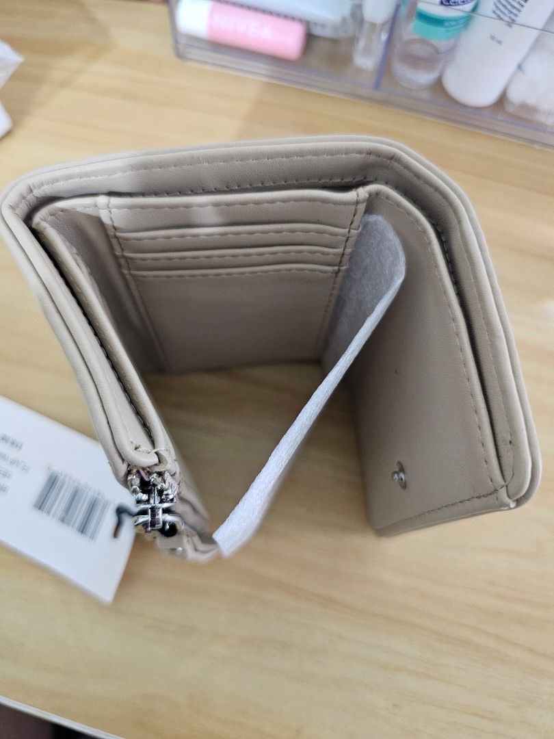 Beige Tri-Fold Wallet with Zipper Coin Pocket (Category: Wallets & Card holders) located in Manila. Submitted by tokyo_thv (Listing ID 1462285178, Image 2). Description: - Adorable beige tri-fold wallet - Features multiple card slots - Includes a convenient zipper pocket for coins - Comes with original tag attached - Ideal for everyday essentials.