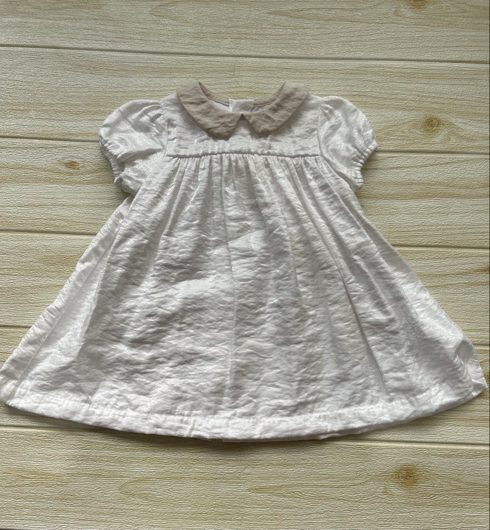 Benebene 12m dress (Category: Babies & Kids Fashion) located in Cebu City. Submitted by yjainani (Listing ID 1462344094, Image 1). Description: soft charming white baby dress featuring short puff sleeves and a soft, contrasting beige rounded collar.