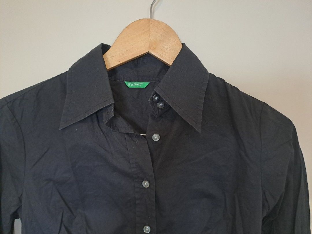 Benetton black longsleve (Category: Longsleeves) located in Manila. Submitted by joanbalde39643 (Listing ID 1462368170, Image 1). Description: This is a women's fitted long-sleeve button-down shirt from the brand United Colors of Benetton. It features a classic pointed collar, a tailored silhouette with front darting for a contoured fit, and tonal black buttons down the placket..