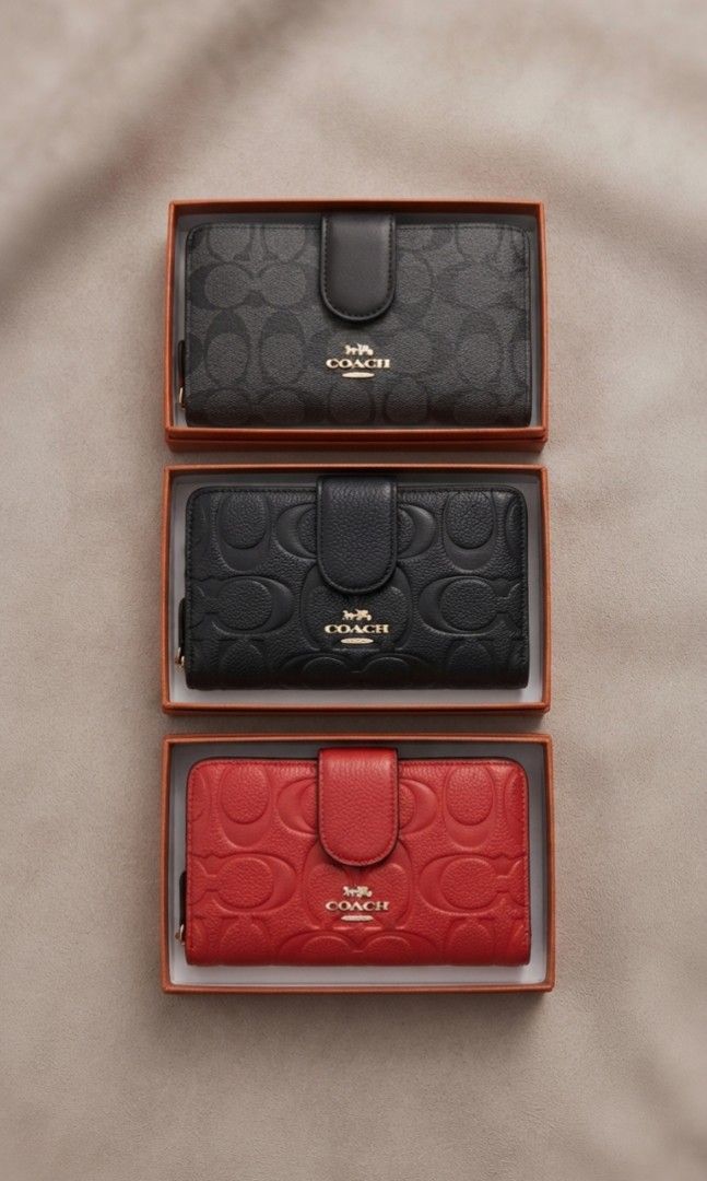 Bi-fold Wallet with zip pocket (Category: Wallets & Card holders) located in Davao. Submitted by nisa_chan04 (Listing ID 1460077878, Image 1). Description: - Medium size wallet in classic black/red with embossed signature C pattern, non embossed design in two-toned color. - Secure zip-around closure and a convenient snap button flap. - Interior features multiple card slots and a clear ID window. - Includes a zippered compartment for coins or smal