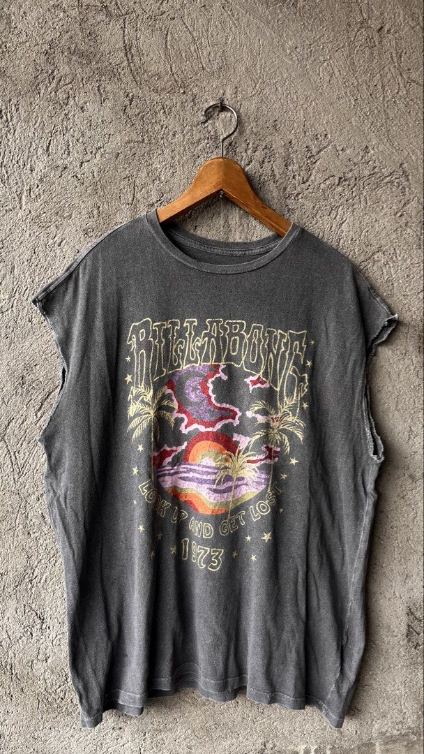 Billabong Graphic T-Shirt (Category: Tshirts & Polo Shirts ) located in Cabuyao City. Submitted by bulandos (Listing ID 1462409096, Image 1). Description: - Cool graphic tee from Billabong - Features a sunset and palm tree design - Text reads 'Look Up And Get Lost 1973' - Sleeveless cut - Great for casual wear.