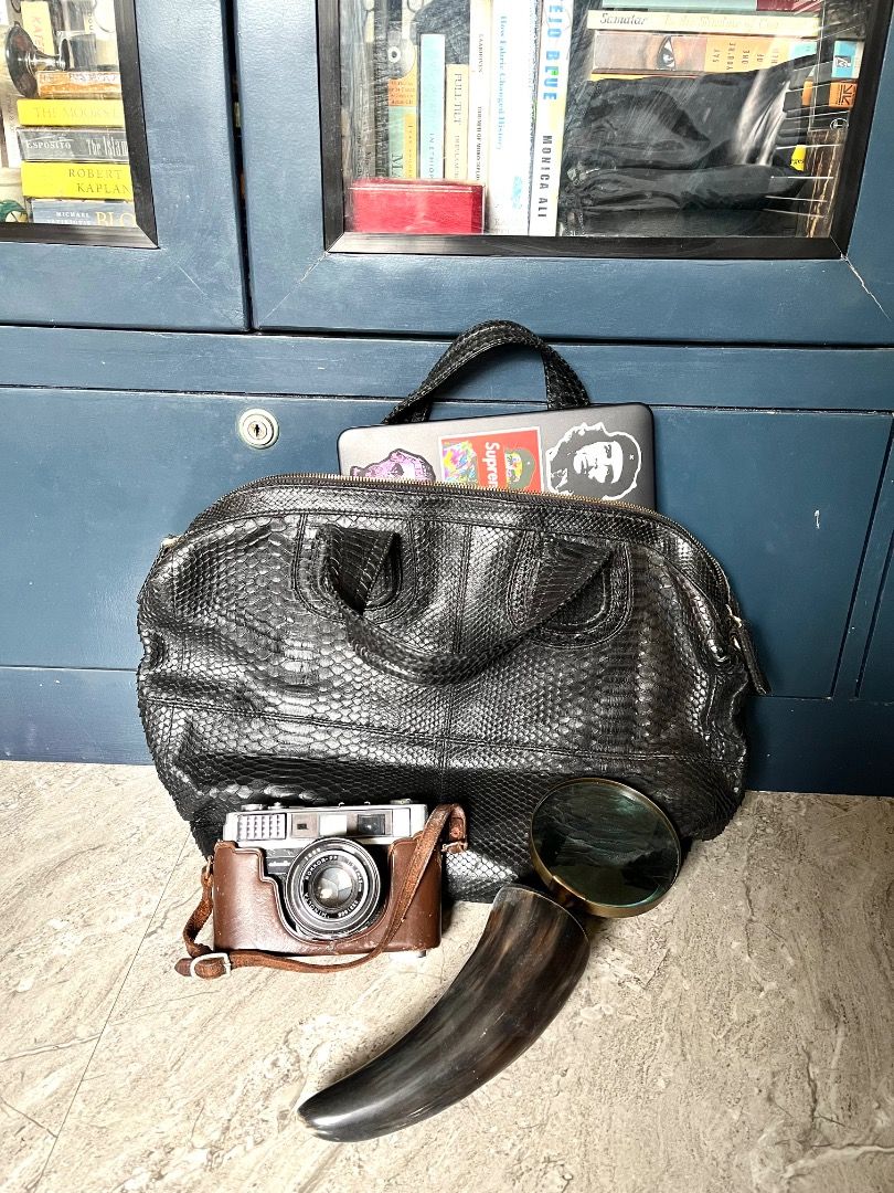 Black Snakeskin Leather Handbag (Category: Purses & Pouches) located in Makati City. Submitted by Ina_Ndang (Listing ID 1462294622, Image 1). Description: - very chic handbag; can be used as laptop or document bag - color is black - genuine snakeskin leather - main bag is zippered; with long strap slot but no strap included - 1 open interior pocket, 1 zippered compartment - navy blue color lining - NO FLAWS but preloved Approximate dimension: 13.