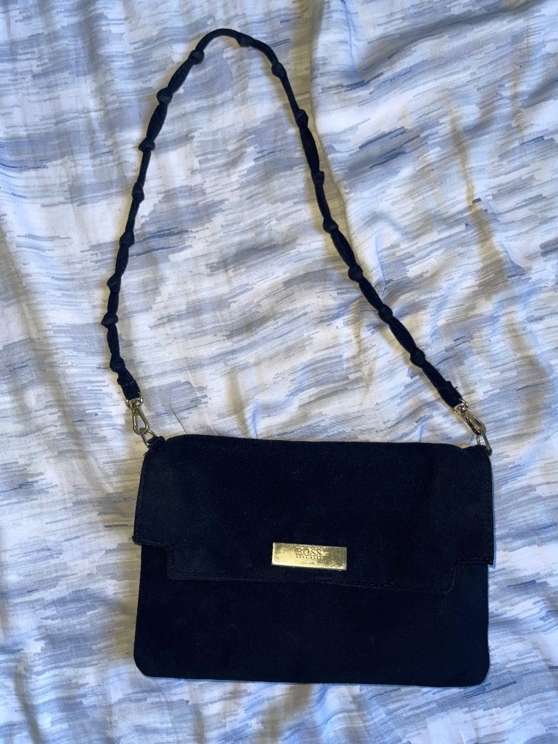 Black Suede BOSS Shoulder Bag (Category: Luxury Bags & Wallets) located in Laoac. Submitted by pj_declutters (Listing ID 1462264814, Image 2). Description: Chic black suede shoulder bag with a gold BOSS logo. Features a braided, beaded strap and a secure snap closure main compartment. Perfect for your essentials!.
