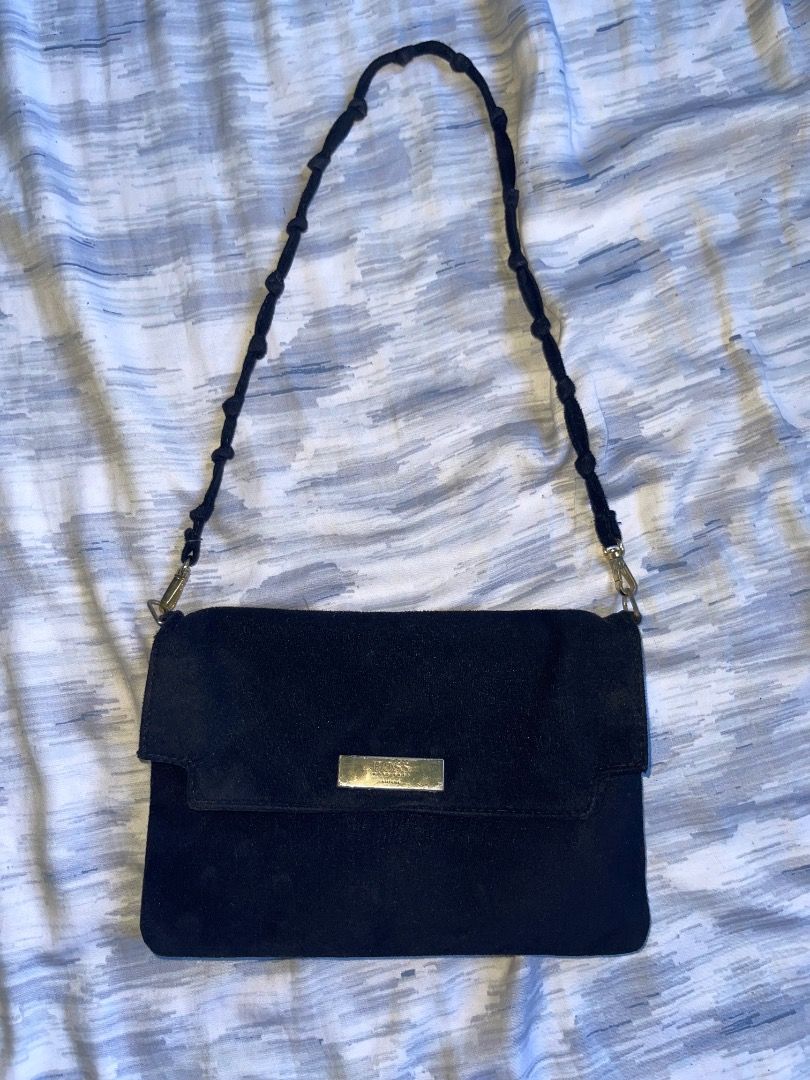 Black Suede BOSS Shoulder Bag (Category: Luxury Bags & Wallets) located in Laoac. Submitted by pj_declutters (Listing ID 1462264814, Image 3). Description: Chic black suede shoulder bag with a gold BOSS logo. Features a braided, beaded strap and a secure snap closure main compartment. Perfect for your essentials!.