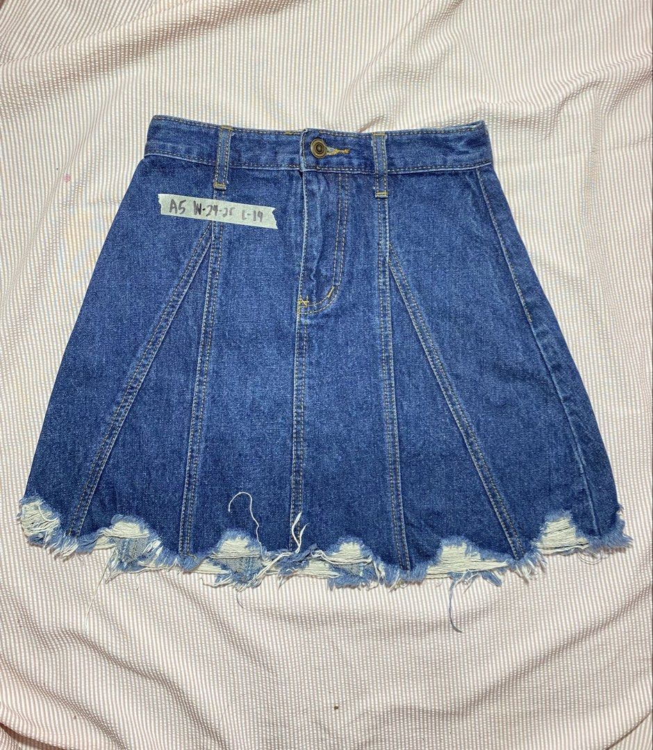 Blue Denim A-Line Mini Skirt with Distressed Hem (Category: Skirts) located in Paranaque City. Submitted by golden_jinkay (Listing ID 1462424652, Image 1). Description: -Waist:24-25 -Lenght:14 - Cute blue denim A-line mini skirt - Distressed, frayed hem for an edgy look - Panel detailing throughout - Button and zip front closure - Ideal for casual wear and easy to style.