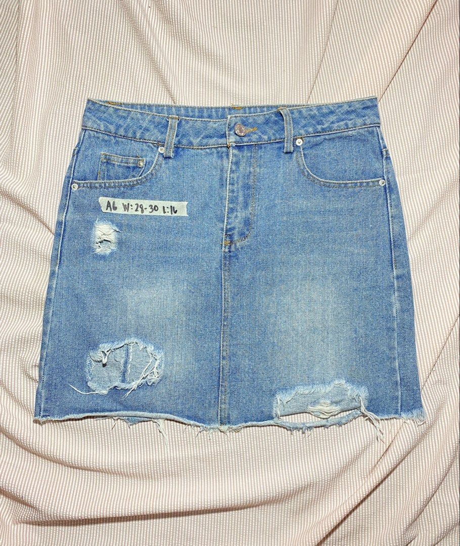 Blue Distressed Denim Mini Skirt (Category: Skirts) located in Paranaque City. Submitted by golden_jinkay (Listing ID 1462424566, Image 1). Description: -Waist:28-30 -Lenght:16 - Classic blue denim mini skirt - Features distressed details and a raw hem - Two front and two back pockets - Button and zip closure - Tag size: W:29-30, L:16 - Ideal for casual wear.