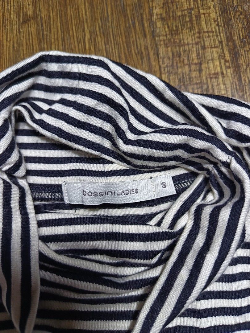 Bossini winter inner warm small women's (Category: Sleeveless) located in Mandaluyong City. Submitted by heatgear (Listing ID 1462365663, Image 3). Description: - Bossini Ladies Striped Turtleneck Top - Classic Black and White Stripes - Long Sleeves - Comfortable Viscose-Elastane Blend - Versatile for Layering or Standalone Wear - Easy to Pair with Jeans or Skirts dimension L 24.5 w 17 S 23 300 + sf location mandaluyong.