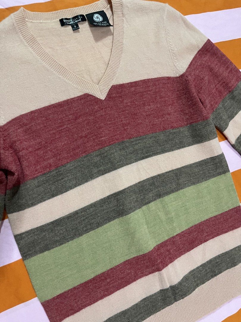 Bossini Y2K Striped Wool Sweater (Category: Coats, Jackets and Outerwear) located in Mandaluyong City. Submitted by hopeworldplane (Listing ID 1462419797, Image 2). Description: - Classic Brooks Brothers v-neck sweater - Features horizontal stripes in cream, burgundy, olive green, and grey - Made from a comfortable wool blend - Versatile for layering or wearing solo - Stylish and comfortable addition to your wardrobe.