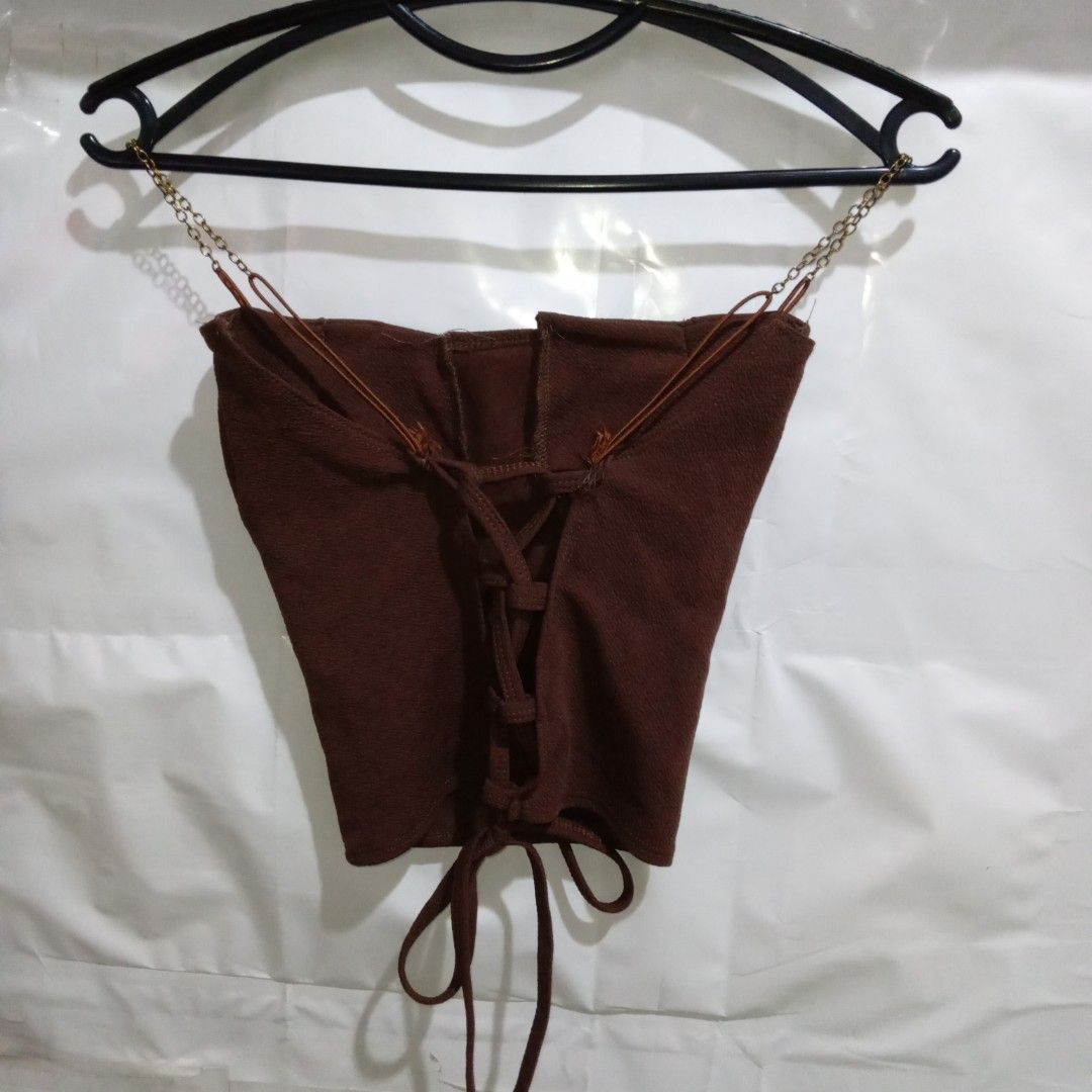 Brown Corset Top with Chain Detail (Category: Others Tops) located in Manila. Submitted by cian.collectives (Listing ID 1462380385, Image 2). Description: ✨ Title: Brown Corset Top with Chain Detail Description: Great and thick fabric, fit to XS-S, with padding and can make ribbon in the back. Comfy to wear. Price: 80.00 Flaws: none Payment Methods: Gcash, Maya (Payment First - No COD) 📍 Note: PLEASE MANAGE YOUR EXPECTATIONS, PRELOVED ITEMS, NO 