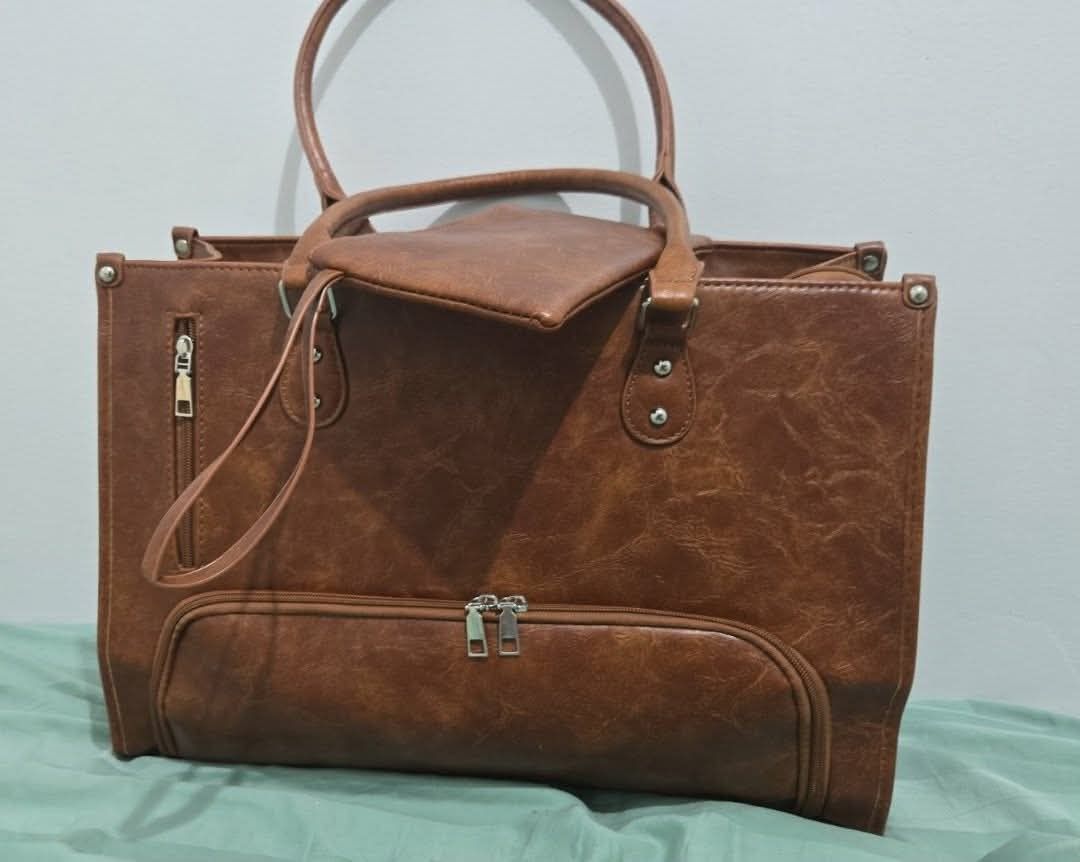 Brown Faux Leather Tote Bag with Pouch and Strap (Category: Tote Bags) located in Manila. Submitted by sari0527 (Listing ID 1462425985, Image 2). Description: Selling this highly practical and stylish 2-in-1 women's laptop work tote bag in a beautiful textured brown color. It was personally purchased in Canada and has only been used once—it is in flawless, like-brand-new condition!This is the ultimate commuter or office bag! It is intelligently s