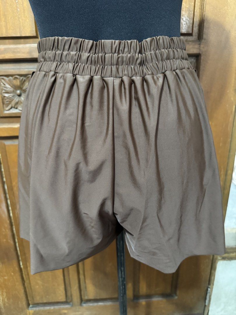 Brown High Waisted Elastic Swim Shorts (Category: Bikinis & Swimsuits) located in Manila. Submitted by prelovedshopmnl (Listing ID 1462284641, Image 2). Description: - Comfy brown shorts - High elastic waistband with drawstring - Slight sheen fabric - Relaxed fit - Ideal for casual wear or lounging - Material: Polyamide and elastane blend - Care: Wash dark colors separately.