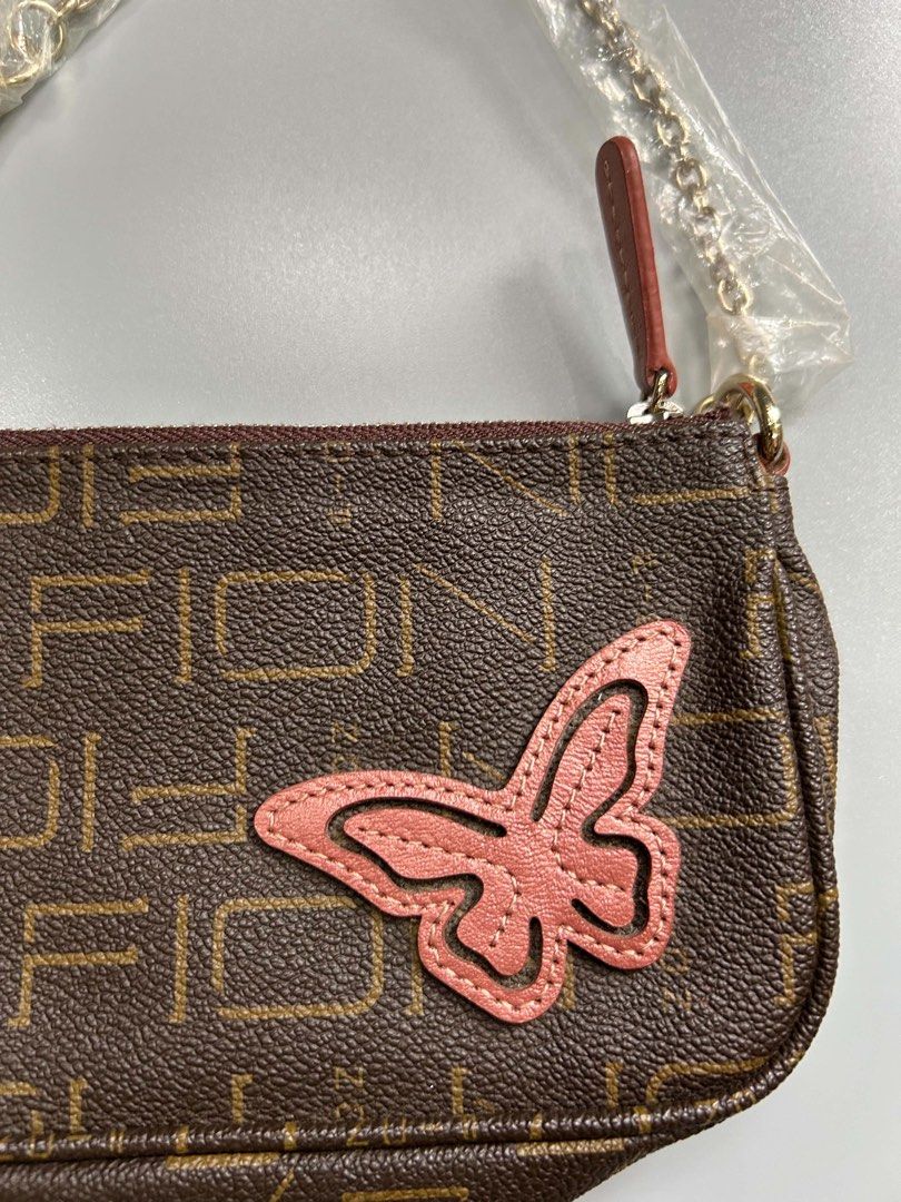 Brown Monogram Butterfly Shoulder Bag (Category: Luxury Bags & Wallets) located in Manila. Submitted by heycessygirl (Listing ID 1462394156, Image 3). Description: - Cute brown shoulder bag - Monogram pattern - Pink butterfly applique on front - Gold chain strap (plastic wrap still on) - Small and compact, ideal for essentials - Zipper closure.