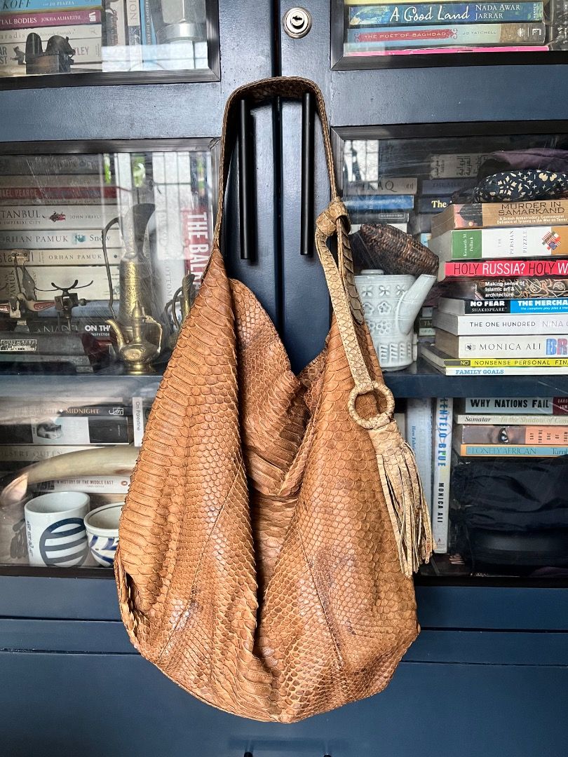 Brown Python Snakeskin Shoulder Bag with Tassel (Category: Shoulder Bags) located in Makati City. Submitted by Ina_Ndang (Listing ID 1462289943, Image 1). Description: - hobo style bag; can fit laptop and other essentials - genuine snakeskin leather - tan brown/mocha color - with interior pockets and removable pochette/small wallet - magnetic button closure - one of my faves among my exotic bag collections FLAWS: - dark stain on exterior, already