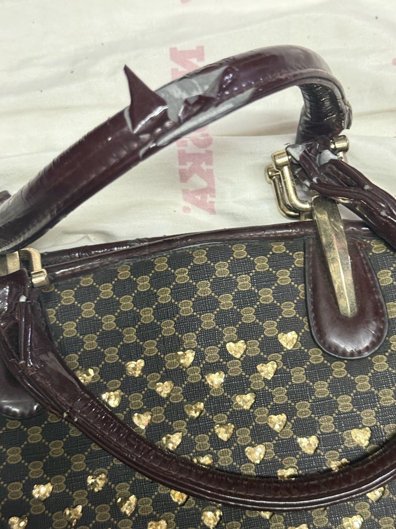 Bundle of 3 Handbags - Various Styles (Category: Tote Bags) located in Manila. Submitted by keixrji (Listing ID 1462295270, Image 2). Description: - Bundle of 3 stylish handbags - Includes: beige faux leather tote, black patent leather shoulder bag with gold hardware, and a patterned tote with heart embellishments - Please note: Some wear and tear on the black bag's strap and the patterned bag's handle. Kindly check photos for detailed condition.