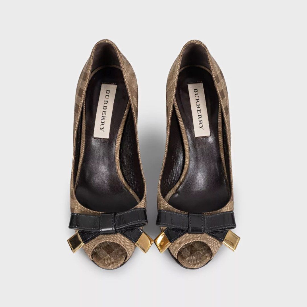 Burberry Plaid Peep-Toe Bow Heels (Category: Heels) located in Bacacay. Submitted by curatedsbyjj (Listing ID 1462303560, Image 1). Description: 100% Authentic. Kindly see photos for the condition. Size 36C on Label, Insole is 25 CM. Heel height is 3.5 inches. No inclusions. Please refer to the 2nd photo for the actual color. > Notes & Reminders: Please manage expectations, as this is a pre-loved item and may have minor flaws that were not notice