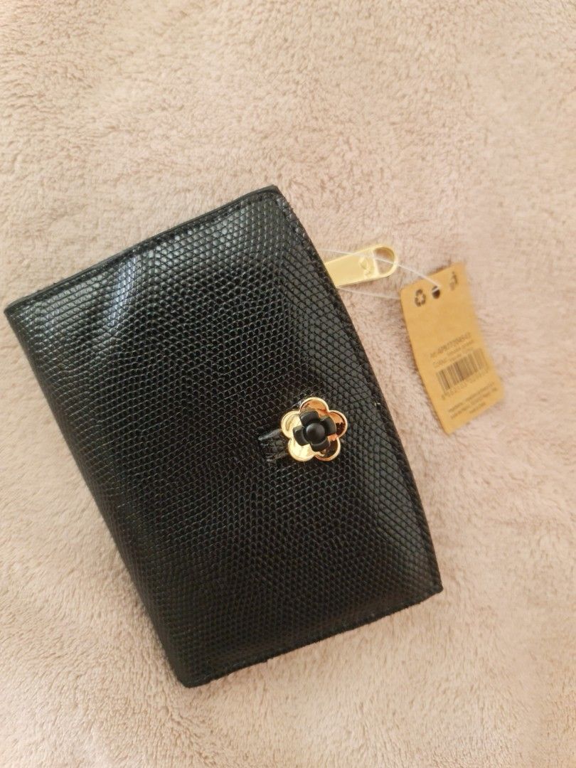 Carpisa wallet (Category: Wallets & Card holders) located in Marilao. Submitted by joycehart (Listing ID 1462287896, Image 1). Description: - Cute black wallet with textured exterior - Small flower detail on front closure - Multiple card slots inside - Zippered coin pocket - Gold-tone zipper and snap button - Comes with original tag.