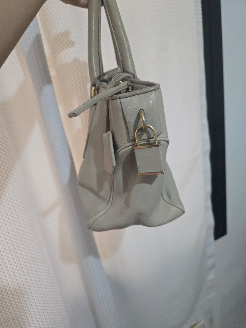 Celine Leather Handbag (Category: Luxury Bags & Wallets) located in Mandaluyong City. Submitted by mariasdesire (Listing ID 1462297086, Image 2). Description: - Beige Color Celine handbag - Made in Italy - Genuine leather material - Top handles - Zip closure - Interior zip pocket and slip pockets - Gold hardware details - Perfect for everyday use - Well used. Expect some flaws but the item is guaranteed authentic.