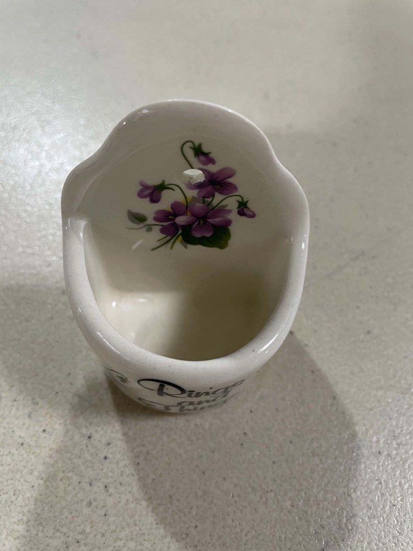Ceramic Wall Pocket "Rings and Things" with Floral Design (Category: Wall Decor) located in Quezon City. Submitted by meggoquingco (Listing ID 1462340635, Image 2). Description: - Cute ceramic wall pocket - "Rings and Things" inscription - Decorated with pretty purple flowers - Ideal for holding small items (jewelry, keys, etc.) - Can be hung on a wall - Dimensions: Approx. 2.5 inches tall, 2 inches wide at opening - Perfect for bedroom or entryw