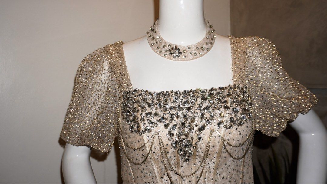Champagne long evening gown (adjustable) (Category: Evening dresses & gowns) located in Manila. Submitted by chichoneyy (Listing ID 1462302918, Image 1). Description: Elegant champagne-colored long gown (filipiana-style/bridgerton-style) adorned with extensive crystal beadwork and a matching choker collar. - color: champagne - size: xs-s - adjustable straps at the back - with matching crystal choker collar - extensive crystal beadwork OPEN FOR RE