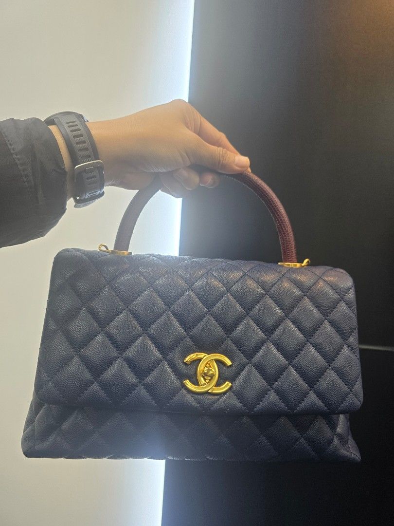 Chanel Coco Small Navy/Burgundy Leather Lizard Top Handle Bag (Category: Luxury Bags & Wallets) located in Taguig. Submitted by mluxeph (Listing ID 1462292023, Image 1). Description: Chanel Coco Small Navy/Burgundy Leather Lizard Top Handle Bag Material: Caviar leather and lizard leather Stamp: 24****** Year: 2017-2018 Interior: One main compartment, one zipper pocket, one pen pocket and two open pockets Measurements: 11.5”L X 4.5”W X 7.5”H Handl