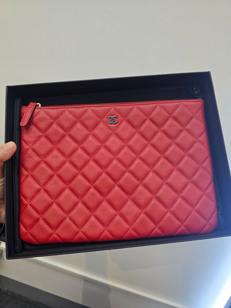 Chanel O-Case Red Quilted Medium Zip Pouch Bag (Category: Luxury Accessories) located in Taguig. Submitted by mluxeph (Listing ID 1462294087, Image 1). Description: Chanel O-Case Red Quilted Medium Zip Pouch Bag Gender: Unisex Material: Lambskin leather Stamp: 20350593 Year: 2014-2015 Interior: One main compartment Measurements: 11”L X 8”H Handle Drop: None Hardware: Gunmetal Inclusions: Original box, original dust bag and authenticity card from 