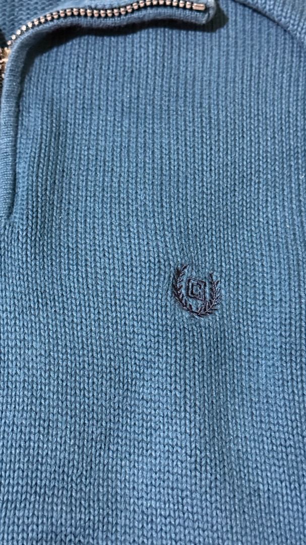 Chaps Blue Cotton Blend Quarter Zip Sweater (Category: Coats, Jackets and Outerwear) located in Balanga. Submitted by jayfinds013 (Listing ID 1462333182, Image 2). Description: - Blue Chaps sweater - Comfortable cotton blend material - Stylish quarter zip neckline - Ribbed cuffs and hem for a snug fit - Features a small embroidered Chaps logo on the chest - Versatile for layering or wearing solo - Measurements in inches: Tag - Small Shoulder - 19