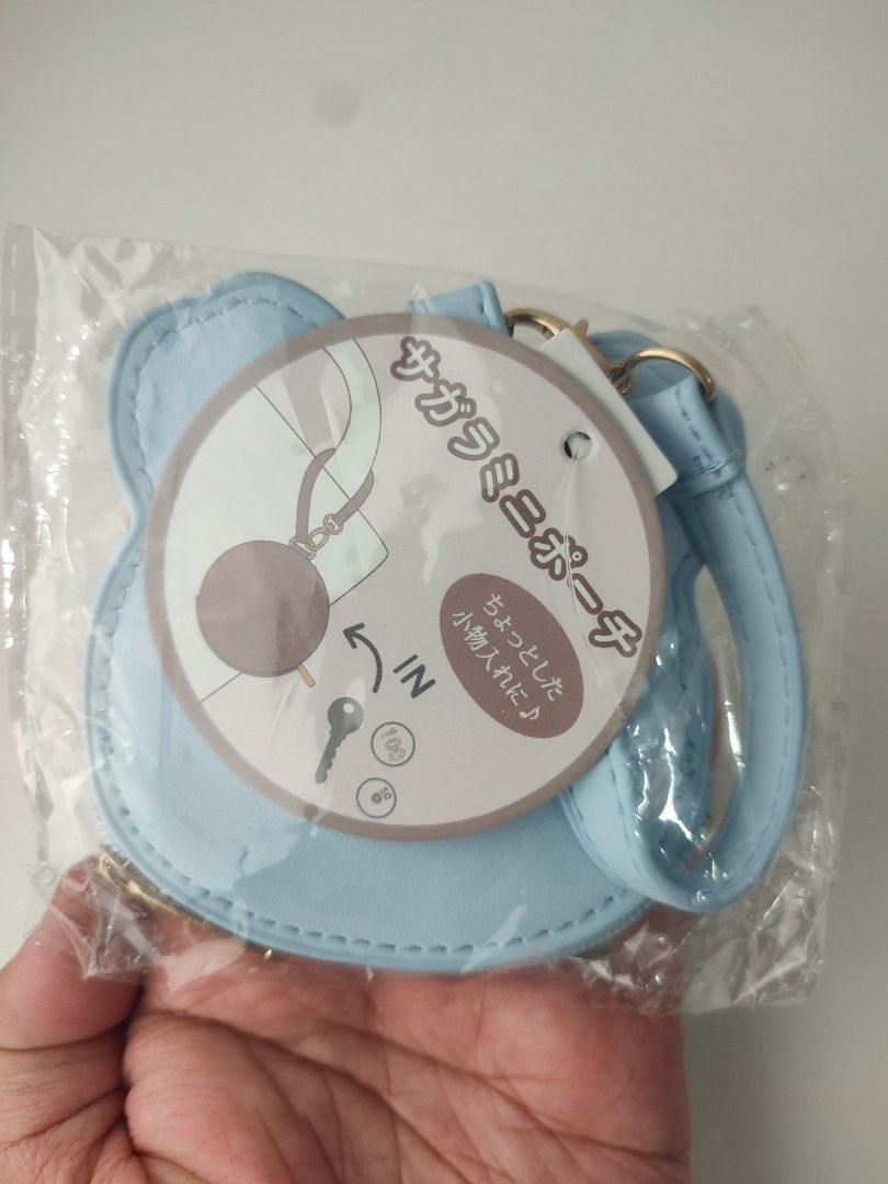 chiikawa face sagara mini pouch (Category: Wallets & Card holders) located in Manila. Submitted by epicmountain-f20453 (Listing ID 1462359963, Image 2). Description: - Adorable light blue coin purse with a cute bear face design. - Features soft pink fuzzy ears and face details. - Secure zipper closure to keep your items safe. - Includes a convenient keychain attachment. - Ideal for storing coins, keys, earbuds, and other small essentials. - A per